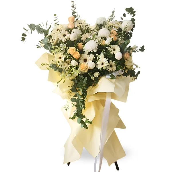 Guardian Angel condolence flower stand with white chrysanthemums, peach roses and eucalyptus