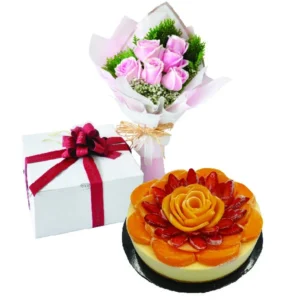 Strawberry Peachy mango cheesecake topped with fresh fruit, paired with a pink rose posy