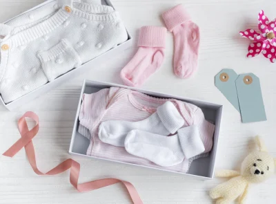 baby-clothing-gift-set-on-white-wooden-surface-2026-03-16-01-20-52-utc