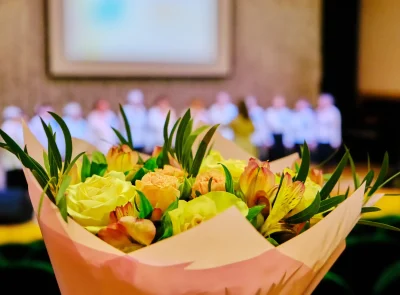 celebratory-flowers-with-backstage-people-blurred-2026-03-26-07-43-54-utc